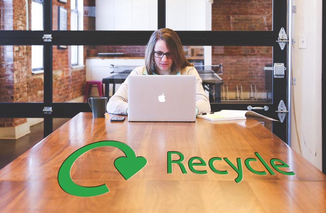 Lady in office with recycling sign